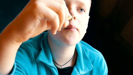 Close-up-view-of-teenager's-mouth.-A-boy-with-an-appetite-is-eating-a-french-fries-in-a-fast-food-restaurant