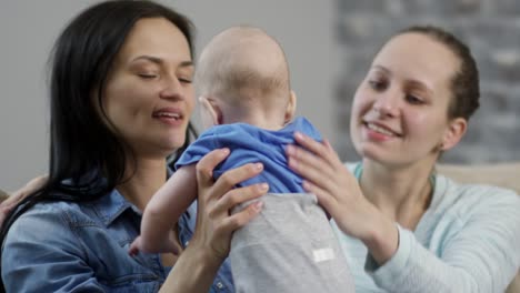 Female-Couple-Playing-with-Baby-and-Hugging