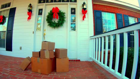 4k-wide-shot-of-Shipping-boxes-by-the-front-door-decorrated-for-the-holidays