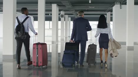 Businesspeople-walking-through-terminal