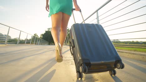 LOW-ANGLE:-Golden-sunset-shines-on-female-tourist-on-her-way-to-the-airport.