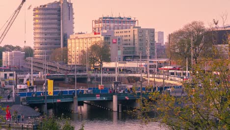 4k-uhd-timelapse--Amsterdam-Central-Station--with-crowd-tourists-walk-on-the--street-with-car-and-transportation-on-street-night-time