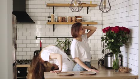 Young-lesbian-couple-have-fun-dancing-at-home