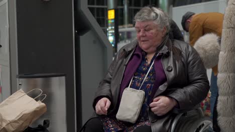 Wheelchair-service-in-airport-terminal,-disabled-person-sitting-in-wheelchair