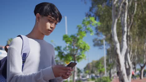 Transgender-adult-using-a-phone-in-the-street