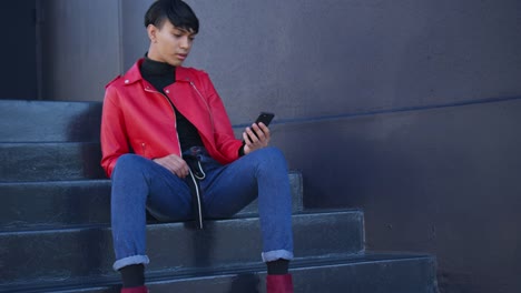 Transgender-adult-using-a-phone-in-the-street