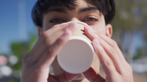 Close-up-view-of-transgender-adult-drinking-coffee