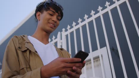 Transgender-adult-using-a-phone-in-the-street