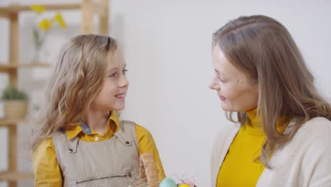 Happy-Woman-and-Girl-with-Basket-of-Easter-Eggs