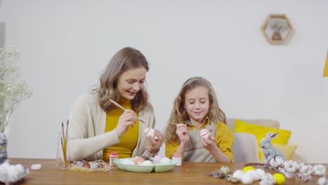 Sequence-of-Happy-Mother-and-Daughter-Painting-on-Easter-Eggs