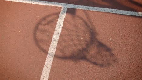 Closeup-portrait-of-shadow-of-basketball-ball-being-thrown-into-a-hoop-outdoors-on-the-court