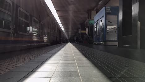 ROMA-/-ITALY---APRIL-25-2019:-Timelapse-of-italian-Termini-railway-station-in-Rome.-People-with-suitcases-are-going-on-platform-near-train.-Monitors-with-train-directions,-clocks.-Sunny-day.