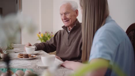 Happy-Easter---Grandfather-and-Granddaughter-Spending-Easter-Together-Talking-at-Home.