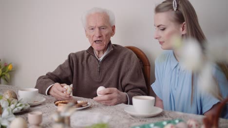 Happy-Easter---Grandfather-and-Granddaughter-Spending-Easter-Together-Talking-at-Home.