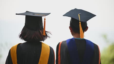 Asian-students-wore-black-frilly-suits,-black-hats,-yellow-tassels-on-graduation-day.