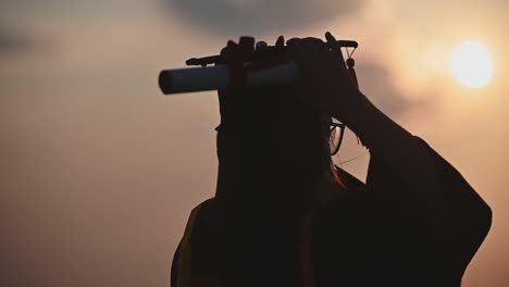 Abstract-Close-up-Rear-view-of-the-university-graduates-at-Silhouette-sunset