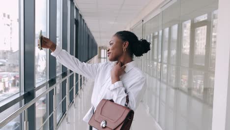 Young-African-American-lady-is-taking-selfies-at-the-modern-hall