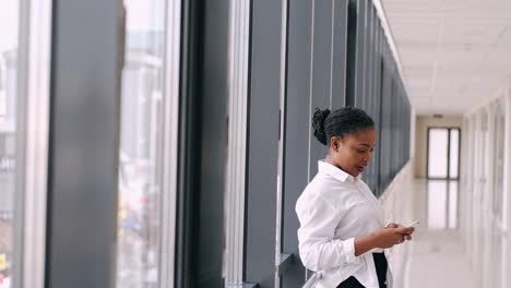 African-American-woman-is-waiting-in-a-modern-hall