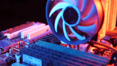 closeup-of-a-rotating-processor-CPU-fan-installed-on-the-motherboard-on-a-black-background