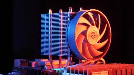 closeup-of-a-rotating-processor-CPU-fan-installed-on-the-motherboard-on-a-black-background