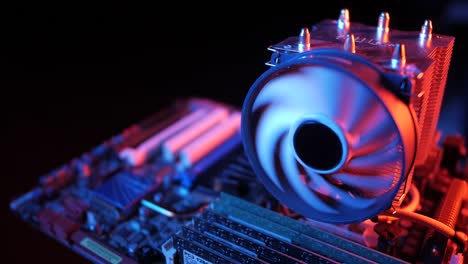 closeup-of-a-rotating-processor-CPU-fan-installed-on-the-motherboard-on-a-black-background