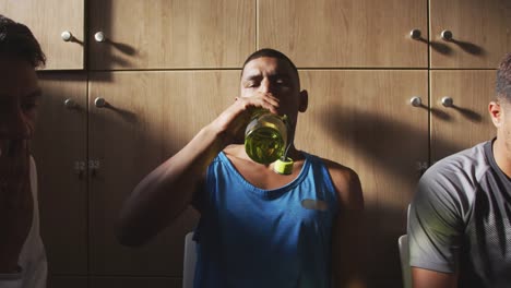 Soccer-player-drinking-water-in-the-locker-room