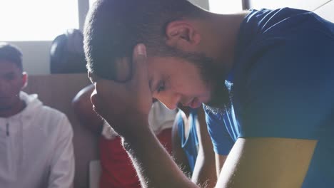 Thoughtful-soccer-player-in-the-locker-room