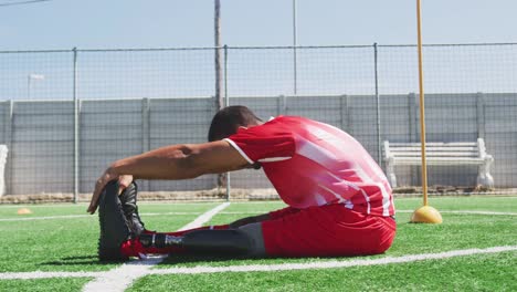 Soccer-player-stretching-on-the-field