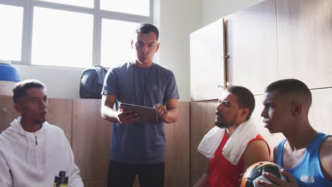 Coach-talking-to-soccer-players-in-the-locker-room