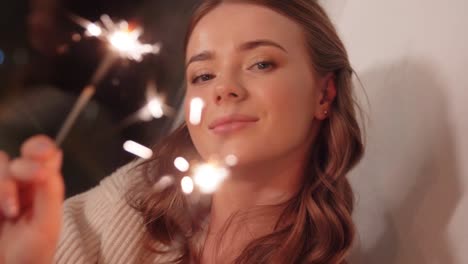 happy-young-woman-with-sparklers-at-home