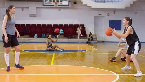 Young-Female-Basketballs-Athletes-Training-Together-on-Court