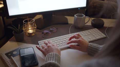 Woman-Working-At-Night-On-a-Computer-At-Home