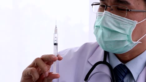 Doctor-holding-syringe-and-talking-to-patient.