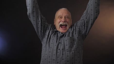 pensioner-poses-and-shows-cheering-football-fan-actions