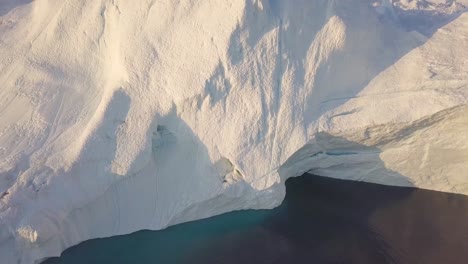 Icebergs-drone-aerial-video-top-view---Climate-Change-and-Global-Warming---Icebergs-from-melting-glacier-in-icefjord-in-Ilulissat,-Greenland.-Arctic-nature-ice-landscape-in-Unesco-World-Heritage-Site.