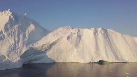 Icebergs-drone-aerial-video-top-view---Climate-Change-and-Global-Warming---Icebergs-from-melting-glacier-in-icefjord-in-Ilulissat,-Greenland.-Arctic-nature-ice-landscape-in-Unesco-World-Heritage-Site.