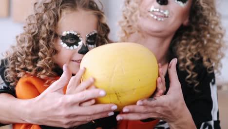 Mother-and-daughter-with-curly-hair-wearing-halloween-costumes