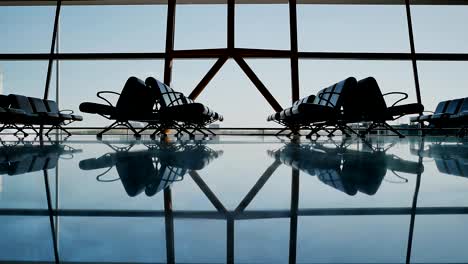 Silhouette-group-of-passenger-walking-with-luggage-at-airport