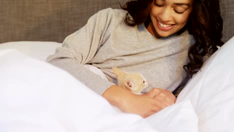 Young-woman-sitting-on-bed-with-her-cat-in-the-bedroom-4K-4k