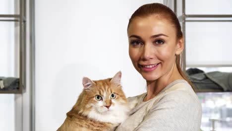 Happy-beautiful-woman-cuddling-with-her-gorgeous-ginger-cat