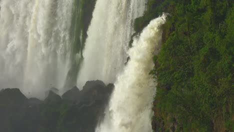 Iguazu-Waterfalls-during-a-morning-summer-full-of-birds,-close-upside-shot-of-the-biggest-cataratas-in-the-world,-Brasil---Argentina.-RED-cinema-camera-footage