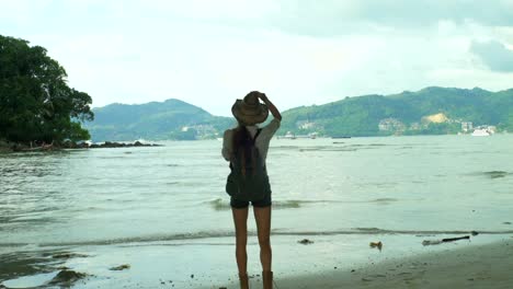 Girl-With-A-Backpack-Standing-In-Front-Of-A-Ocean