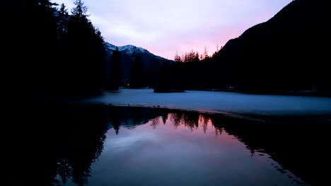 Frozen-lake-and-ducks-sunset,-slowmotion