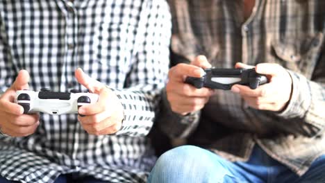 Male-and-female-hands-playing-video-game-at-home.-Shooting-and-controlling-using-the-game-controller