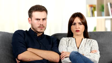 Angry-couple-arguing-sitting-on-a-couch-at-home