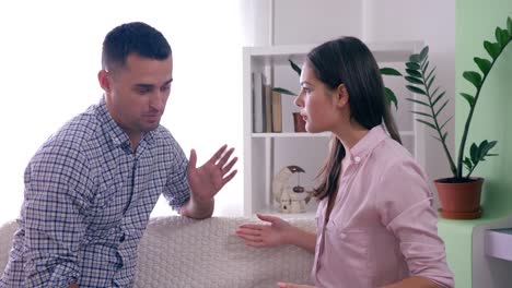 family-quarrel,-emotional-Angry-woman-swears-with-spouse-and-rageful-gestures-hands-during-dispute-in-room