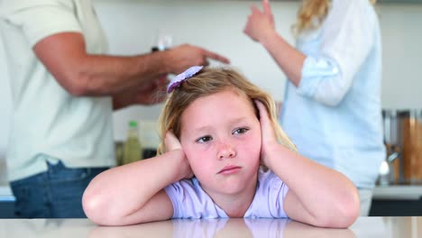 Little-girl-blocking-out-noise-from-parents-fighting