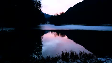 Frozen-lake-and-ducks-sunset,-slowmotion