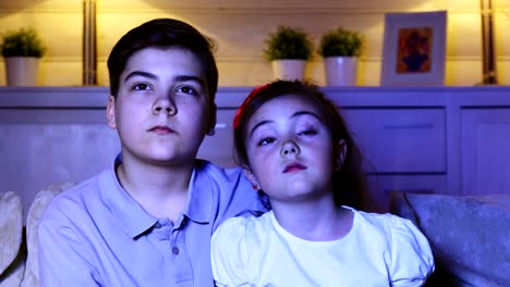 Boy-with-his-sister-watching-TV