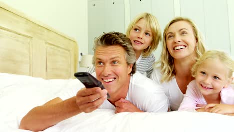 Happy-family-watching-television-in-the-bed-room-4k